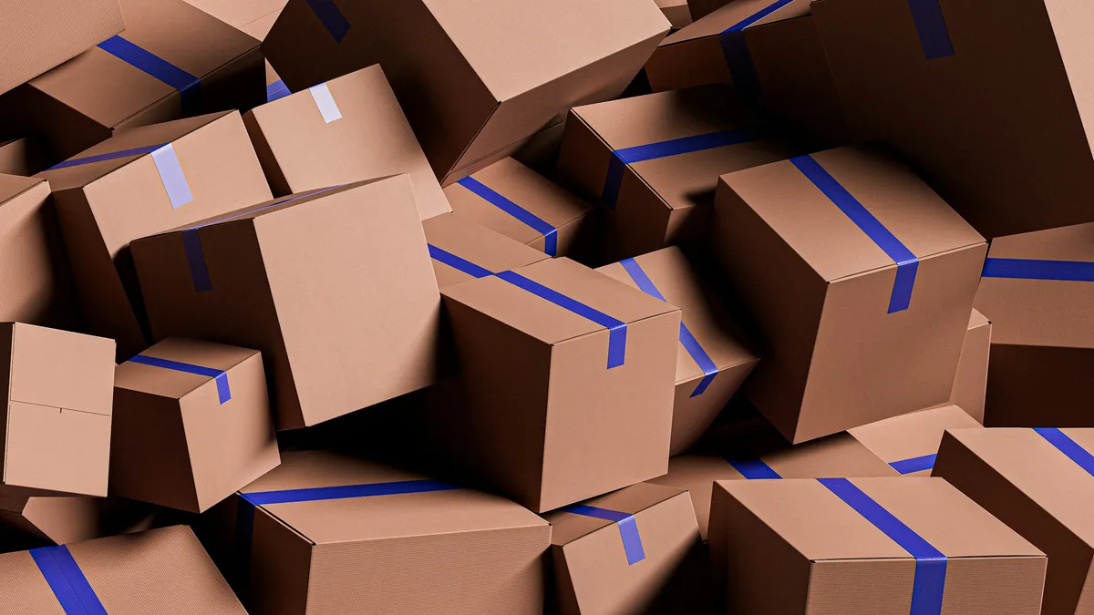Large pile of brown cardboard boxes sealed with blue tape, ready for moving
