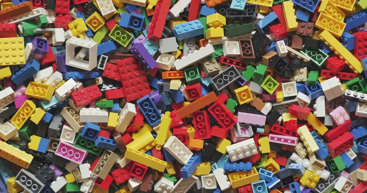 A large pile of colorful plastic building bricks in many shapes and sizes
