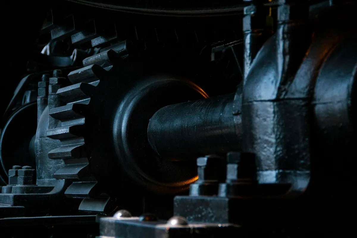 Close view of interlocking black metal gears in an old machine
