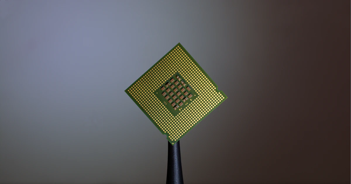 A hand holding a computer processor chip
