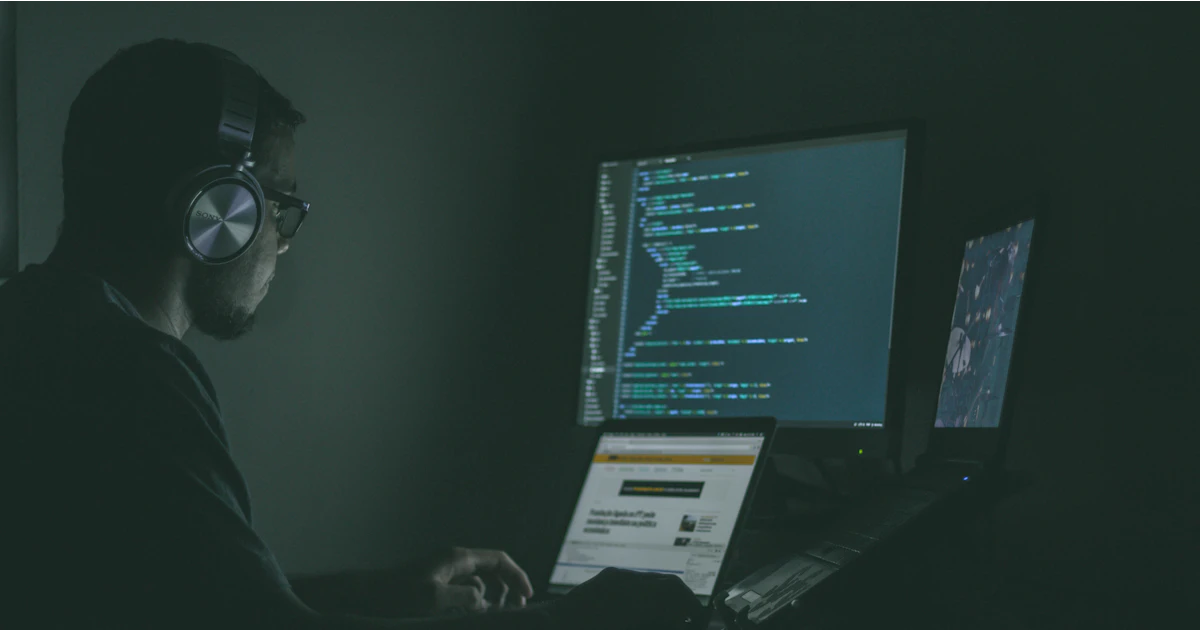 A person using a laptop showing code