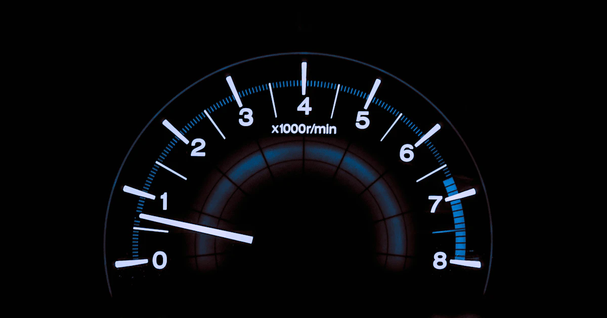 A white and blue analog tachometer gauge