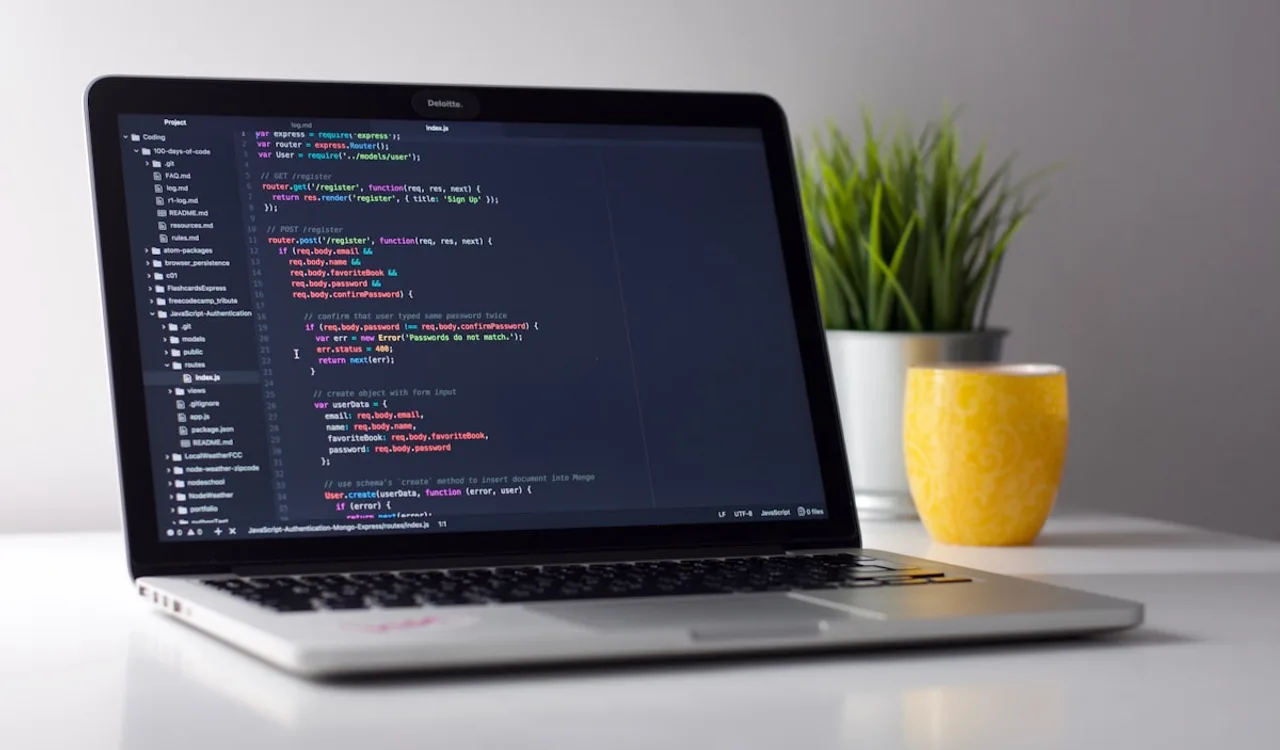 Developer reviewing test output in a terminal alongside React component code on a second monitor