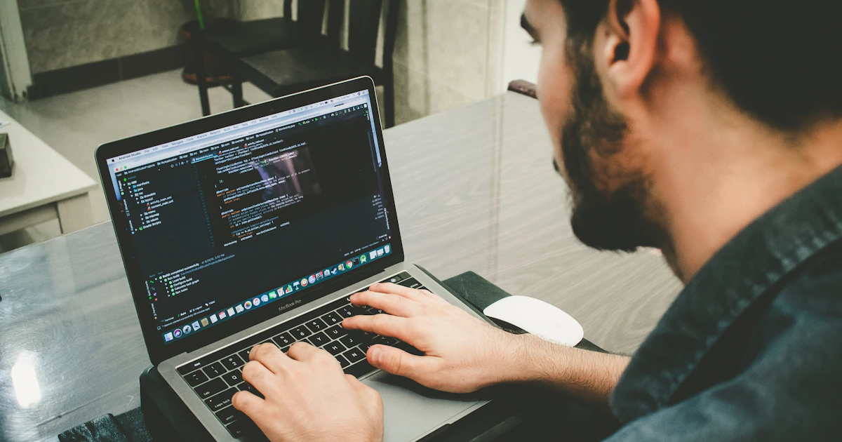 A developer programming on a laptop