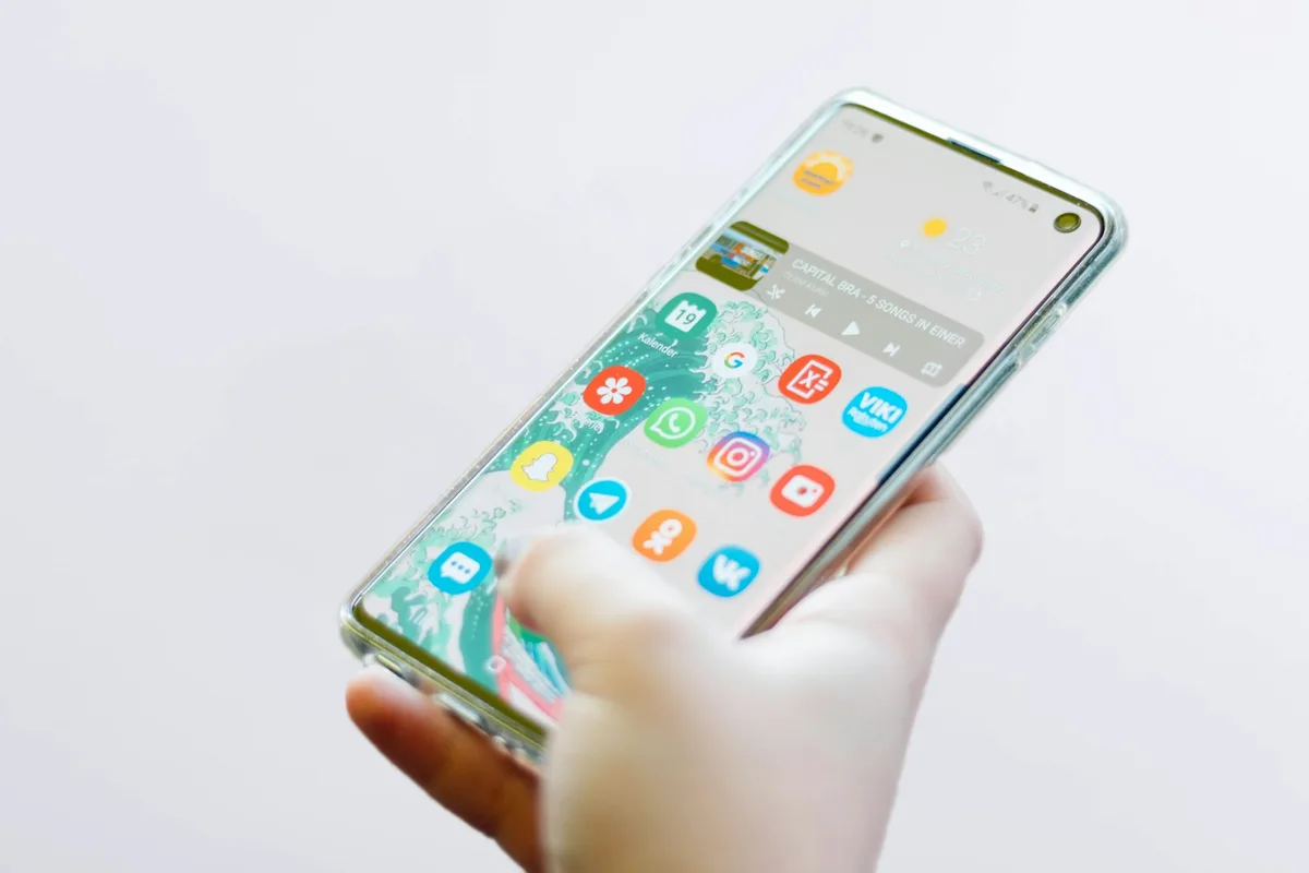 Person using a silver Android smartphone