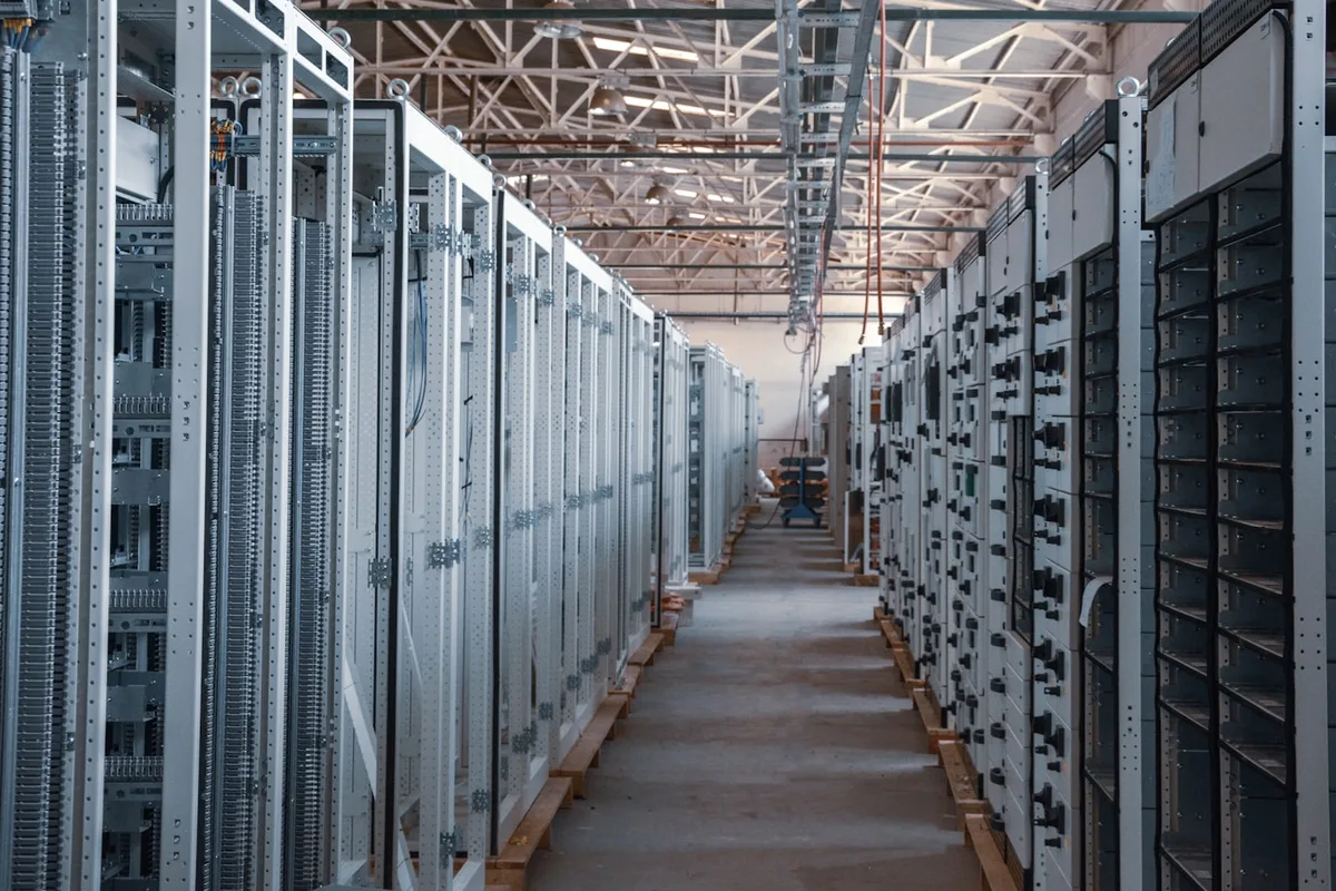 Server room aisle lined with equipment racks