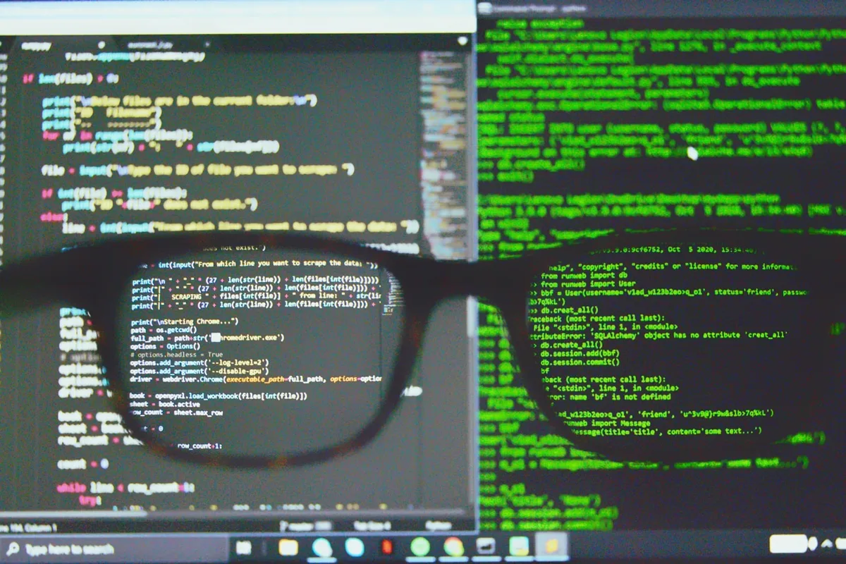 Glasses resting in front of a screen full of code