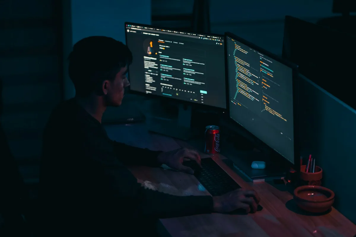 Developer typing at a desktop workstation
