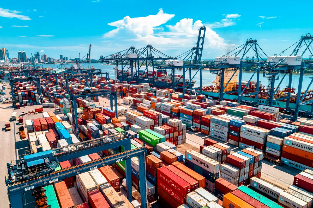 Shipping containers stacked several rows deep at a working harbour