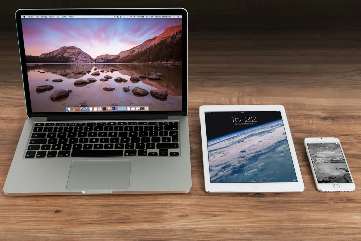 A laptop, tablet, and phone side by side showing the same content across screen sizes