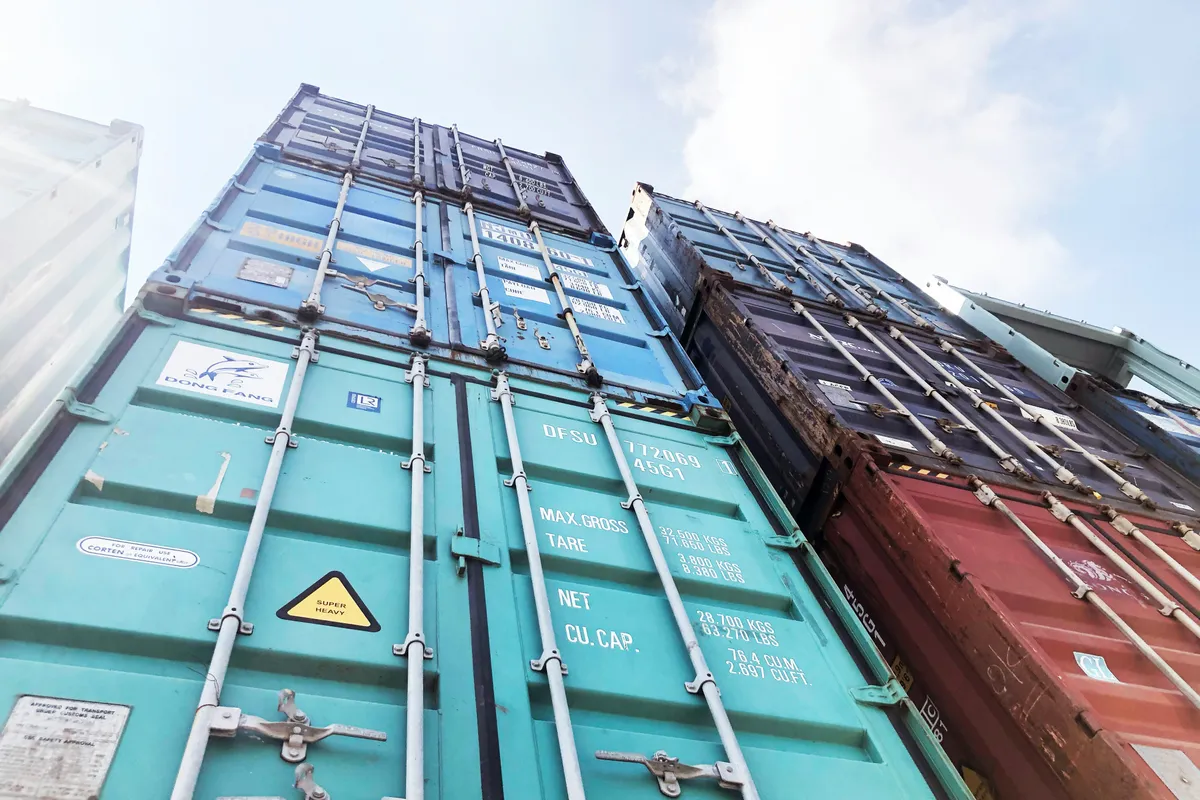 Closed steel container door photographed against an open sky