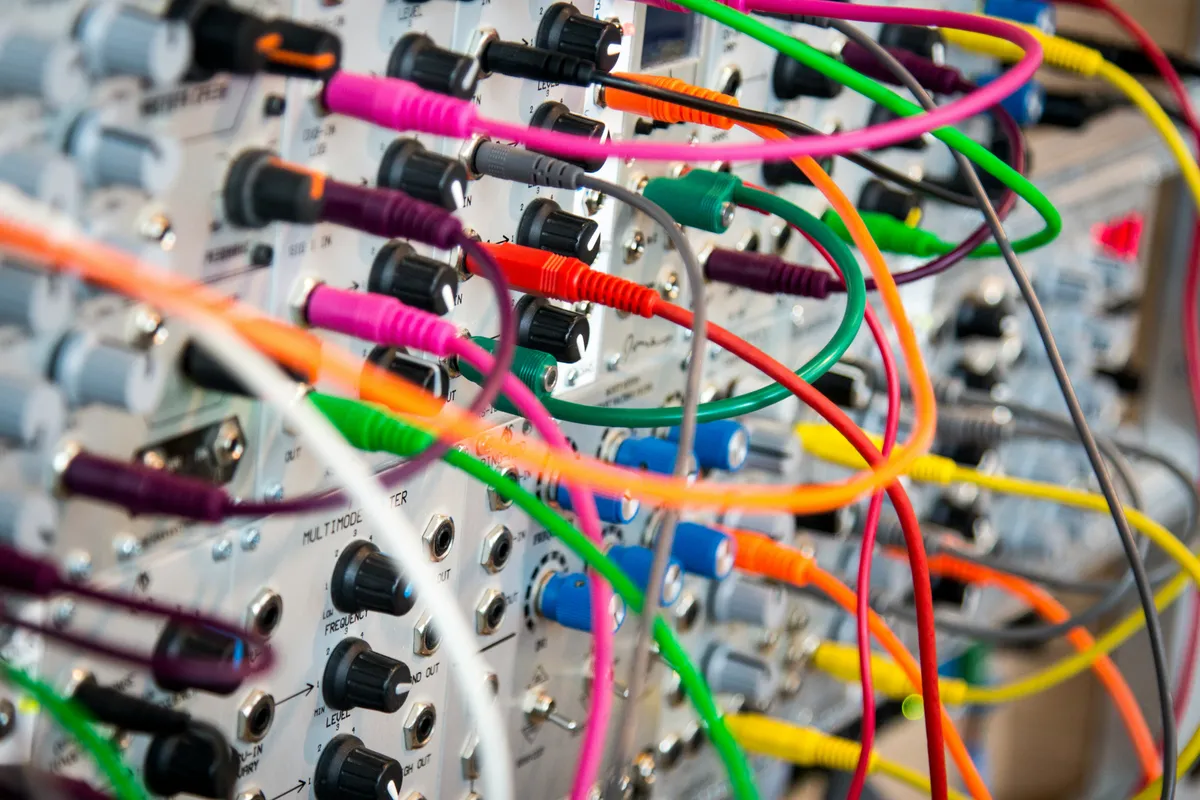 Brightly colored patch cables connecting the modules of a modular synthesizer