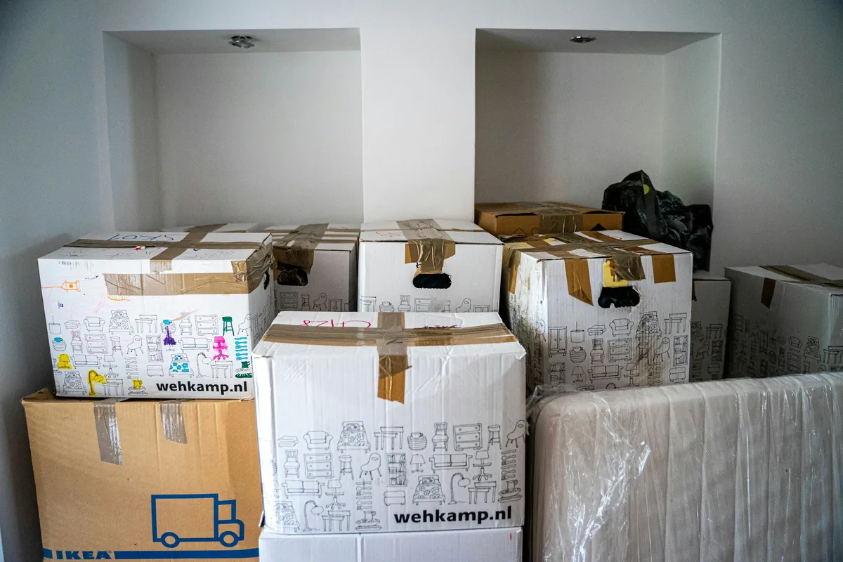 Several brown cardboard boxes of different sizes arranged on a wooden table