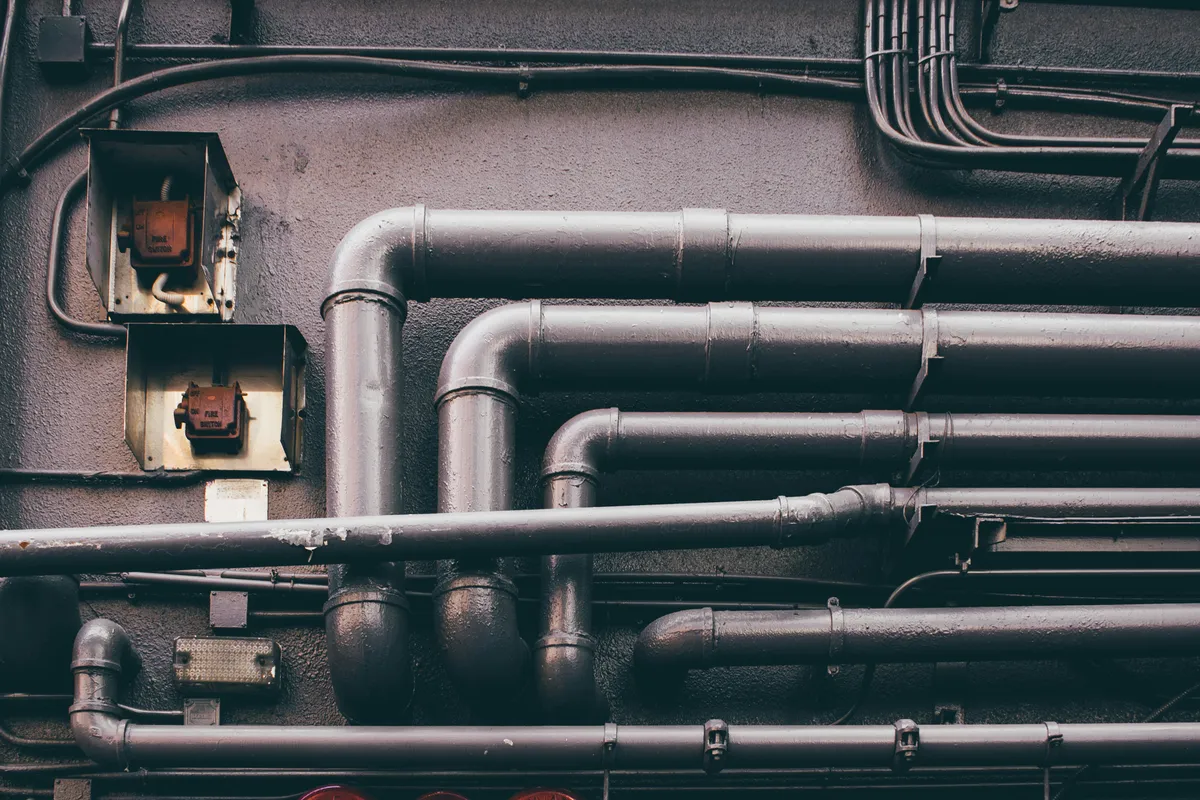 Stacked metal tubes waiting to be joined into a single line