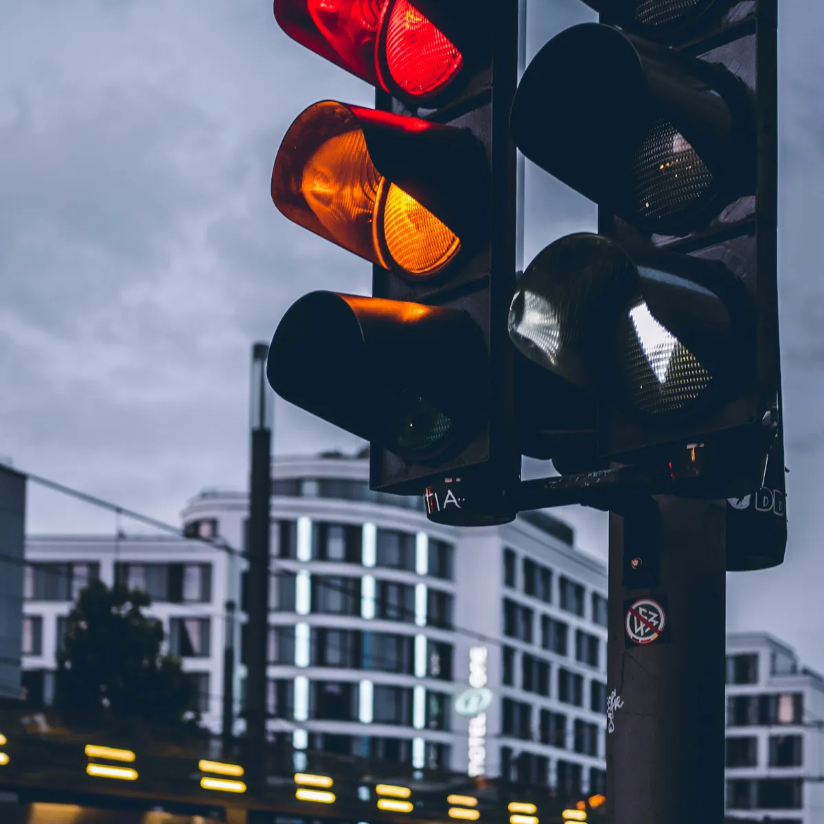 A red and orange traffic light signaling stop, evoking a rule being broken on purpose