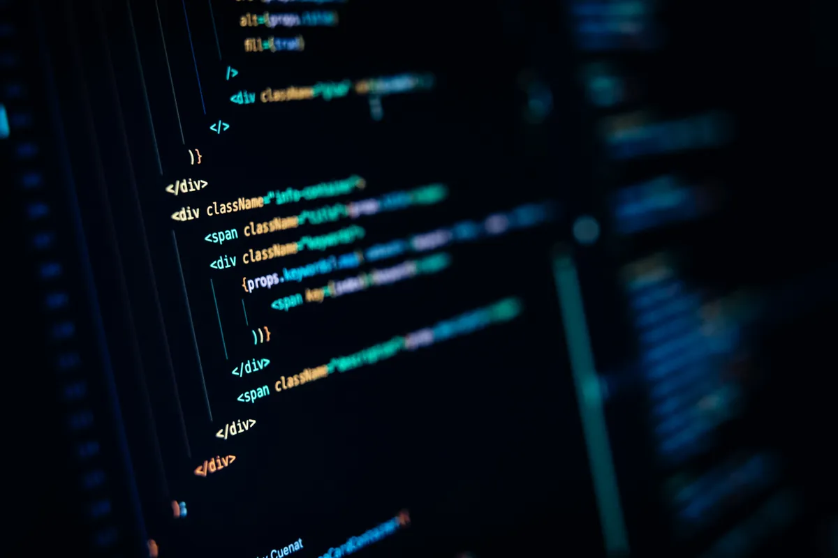 Close-up of typed JSX source code with className and props on a dark editor screen