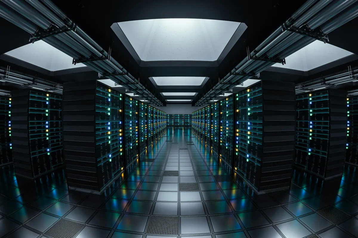 Rows of illuminated server racks in a data center corridor