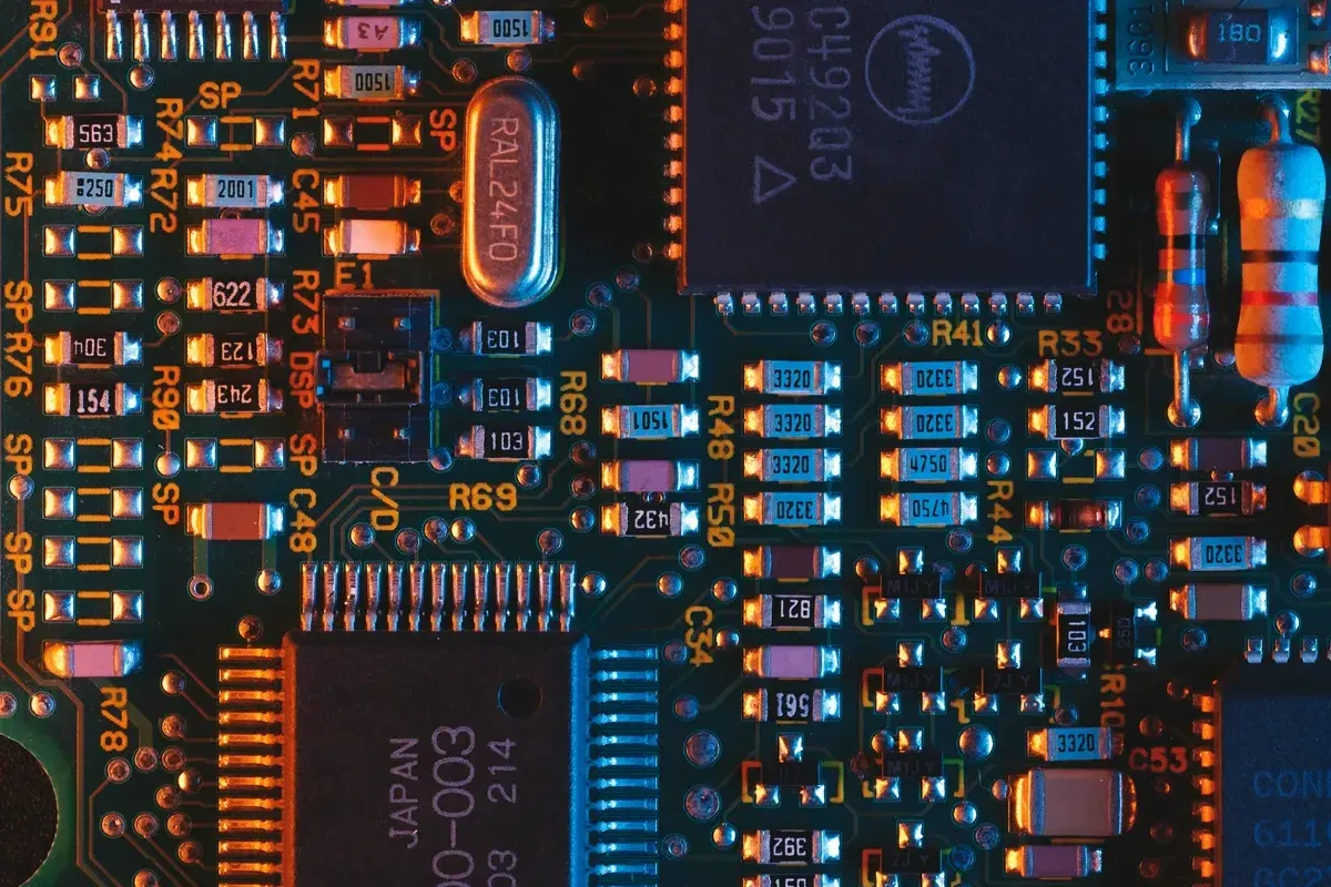 Close-up of a blue printed circuit board with surface-mount chips