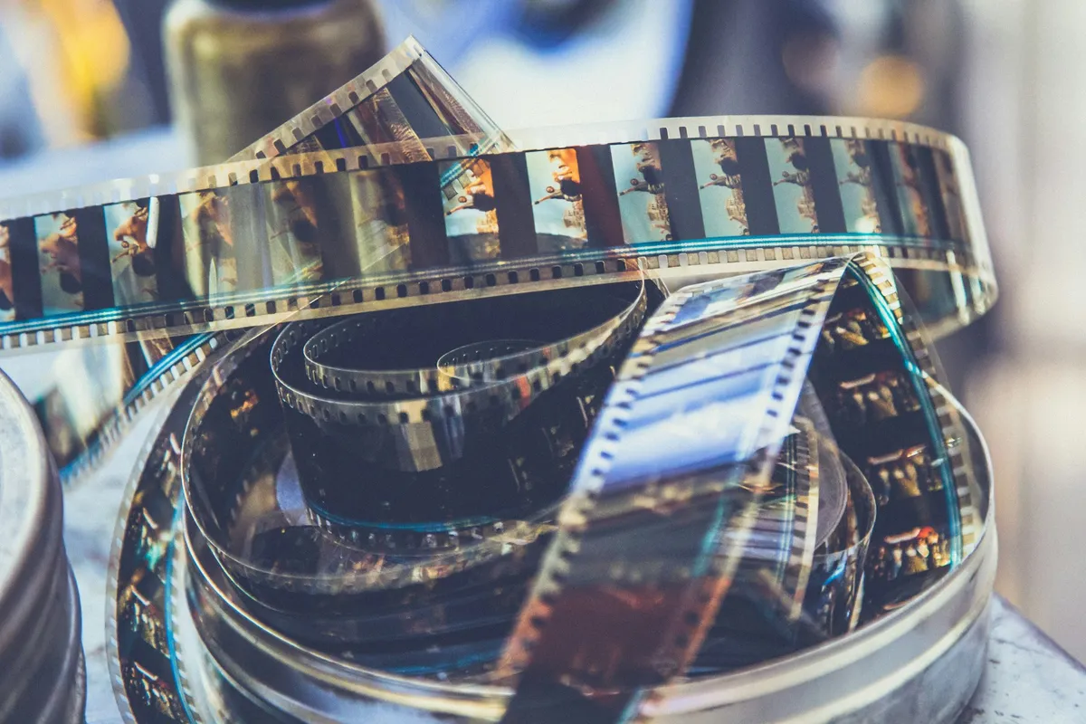Coil of photographic negative film unrolled on a surface