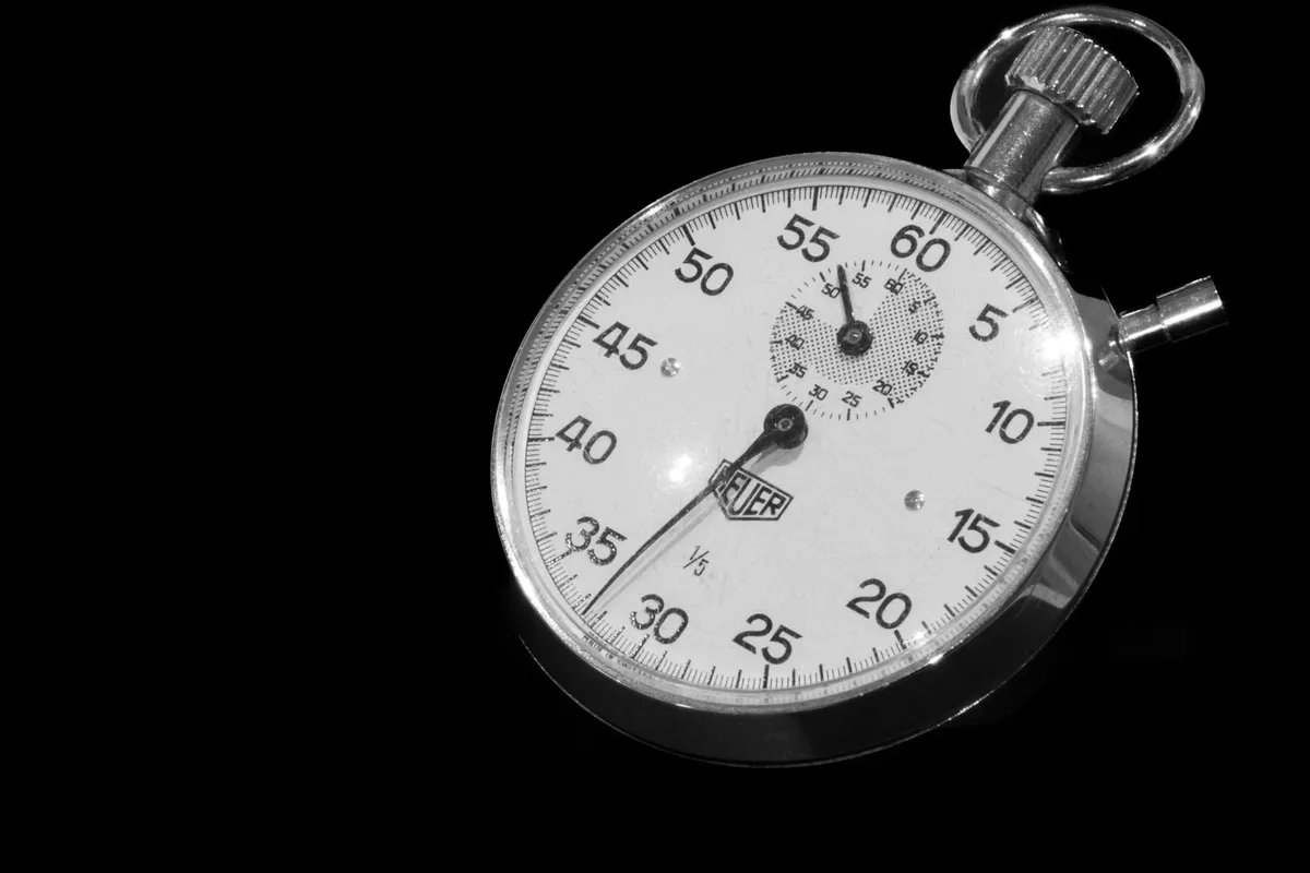 Close-up of a stopwatch face against a black background